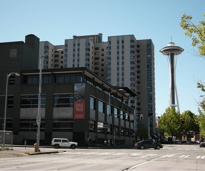 Exterior view of a downtown Seattle building with the Space Needle in the background