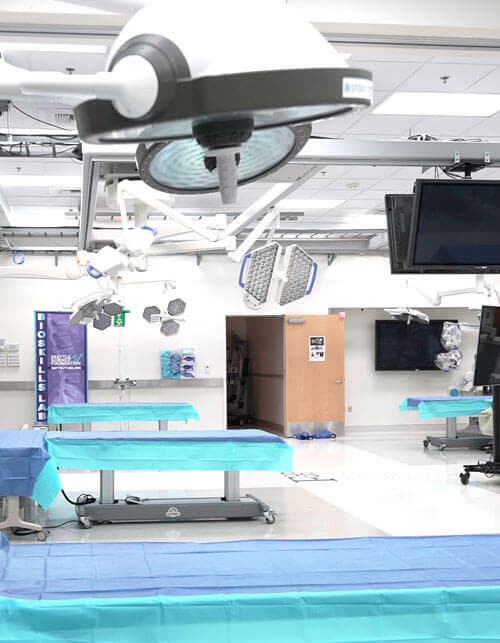 Medical research facility, beds in an open room with large medical equipment
