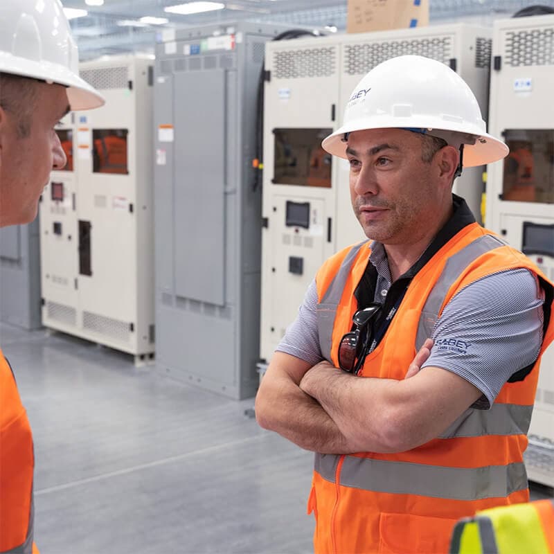 Two people in hard hats in a data center