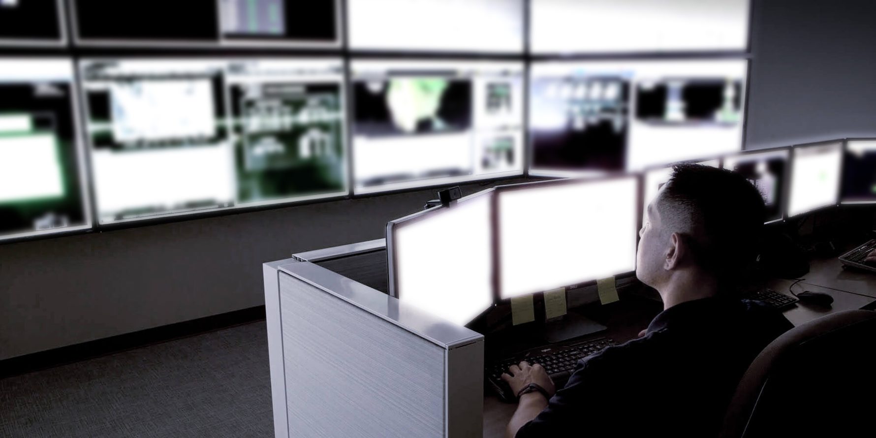 Sabey data center control room with multiple computer monitors and one operator