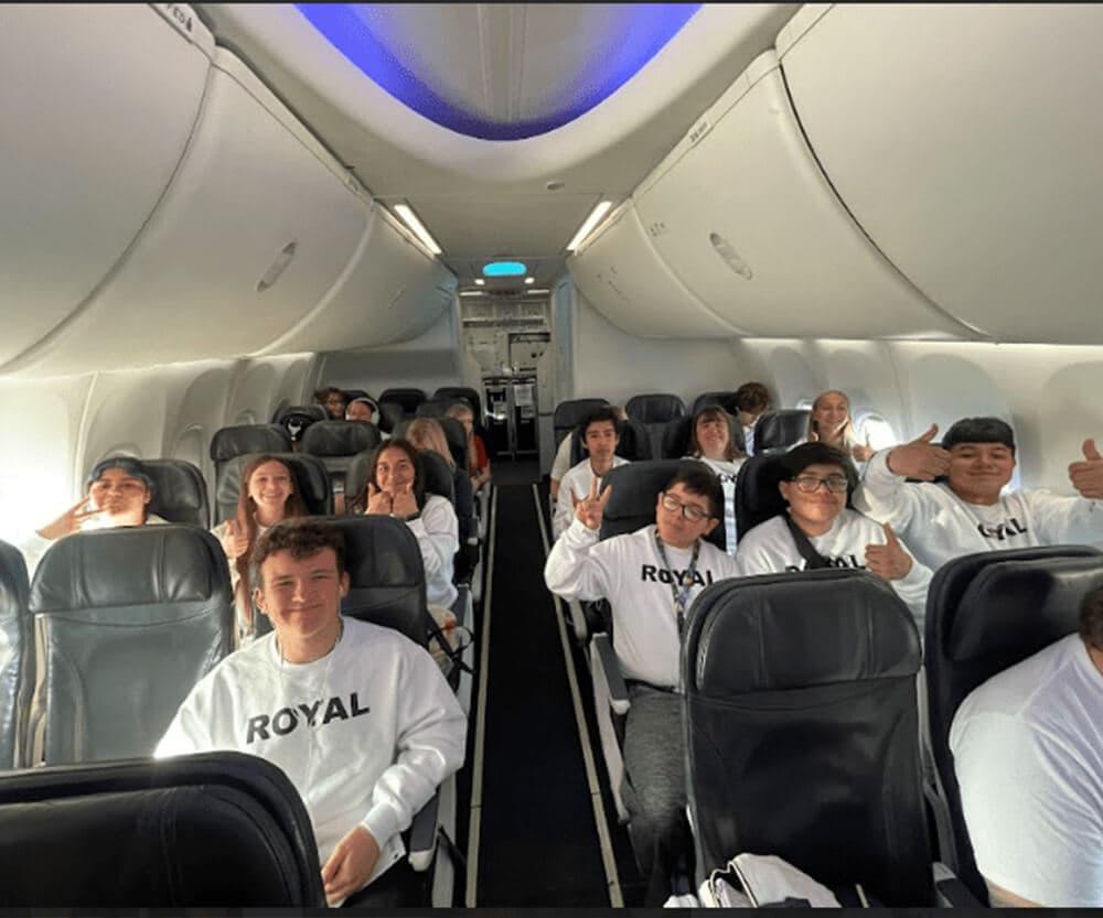 Team of middle school students on a plane