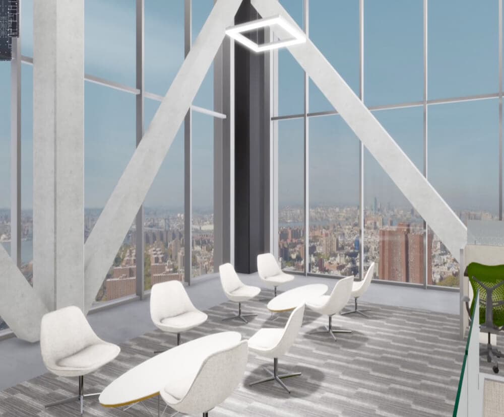 Empty chairs in a large office room with windows filling the walls looking out to a city skyline.