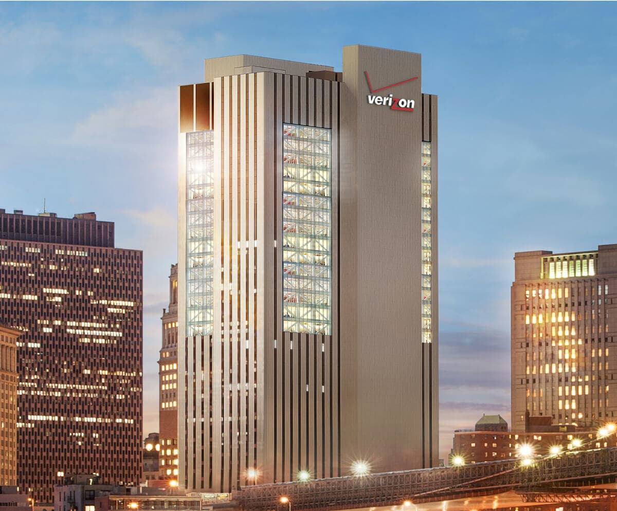 A tall white building with a "Verizon" logo on the top.