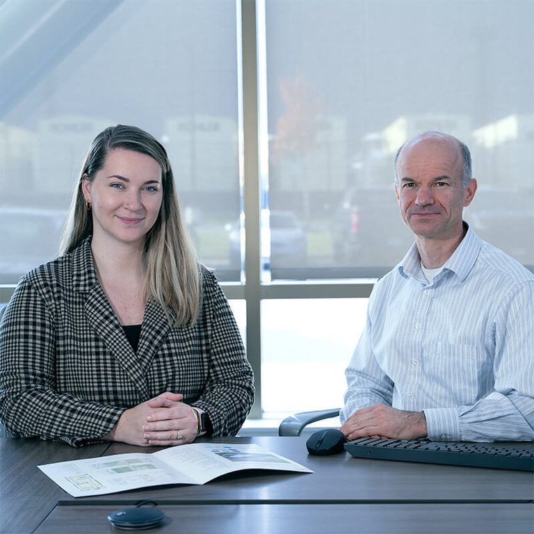 Coworkers sitting at a table in front of a window