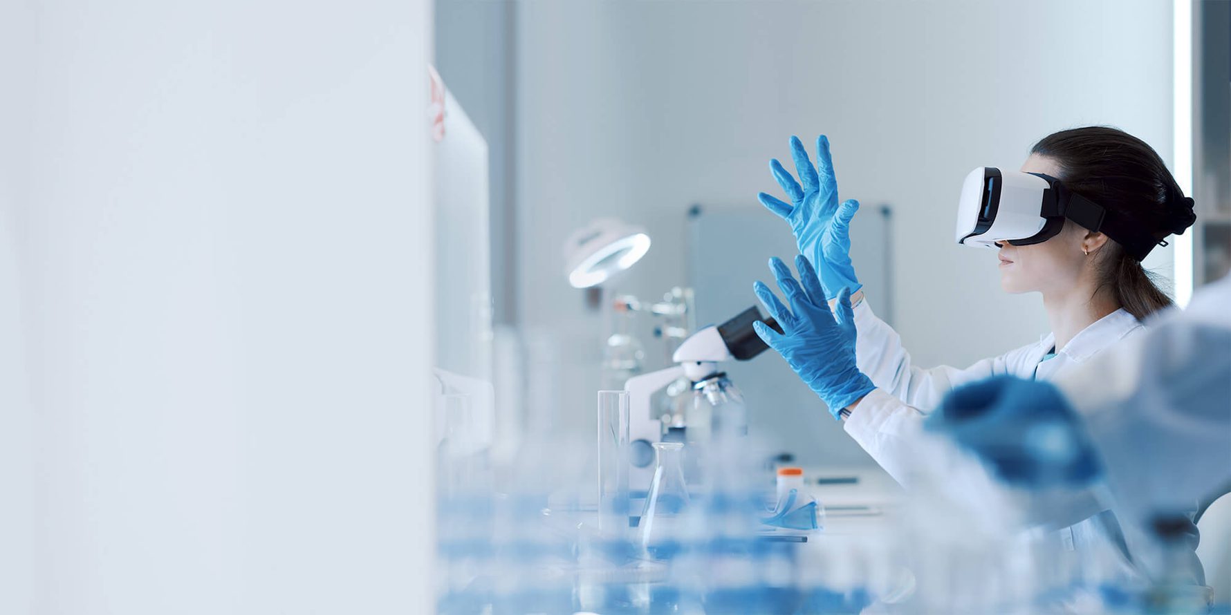 person looking using a microscope with a VR headset