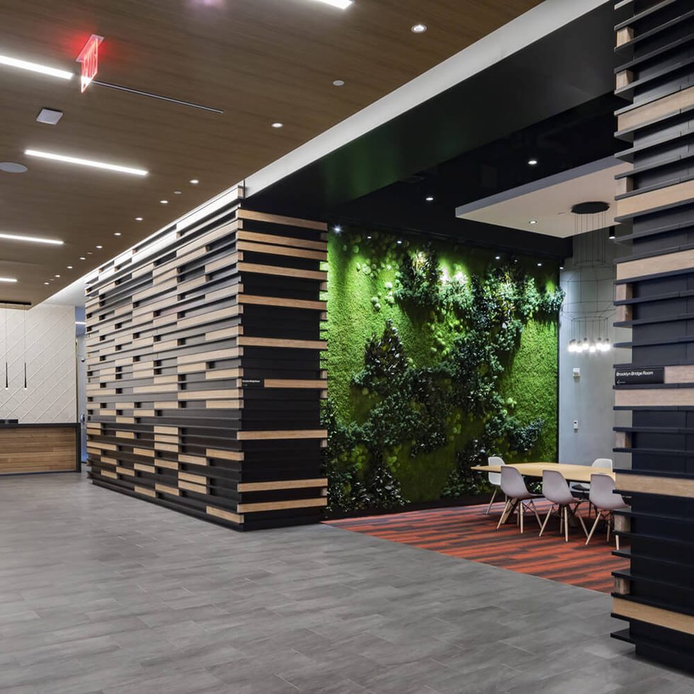 Lobby of 375 Pearl Street with a sitting area and wall of plants