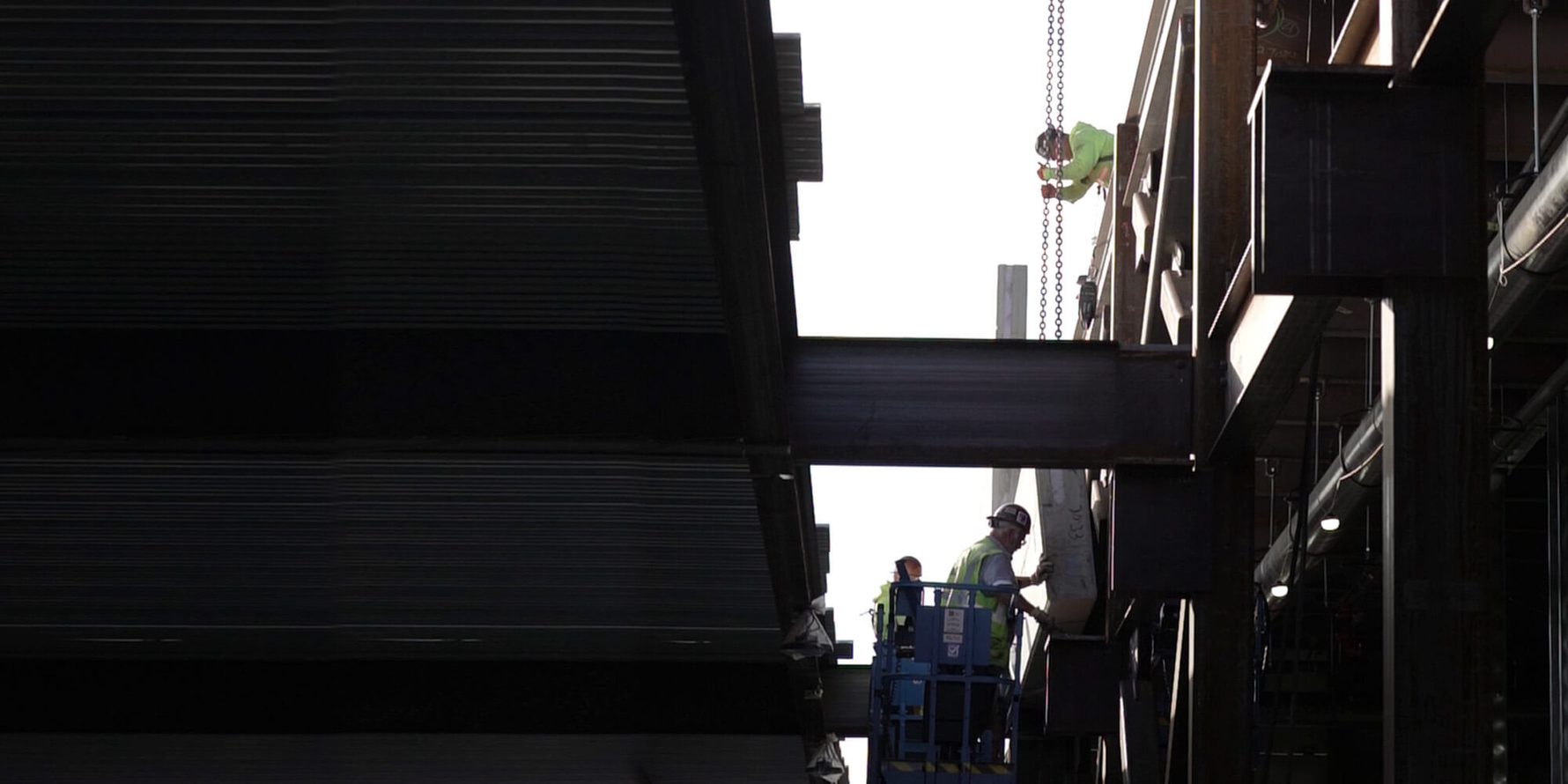 Builders working with steel beams constructing a data center