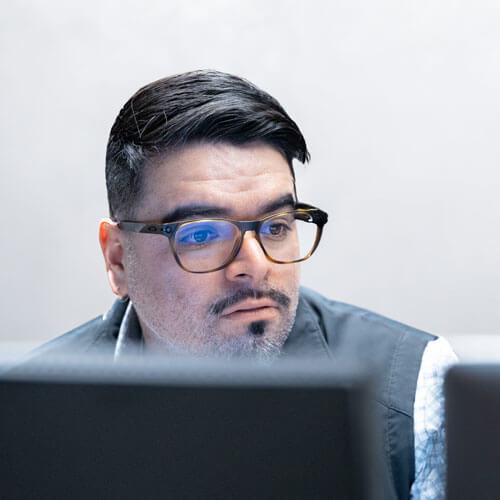 Office worker sitting in front of two computer monitors
