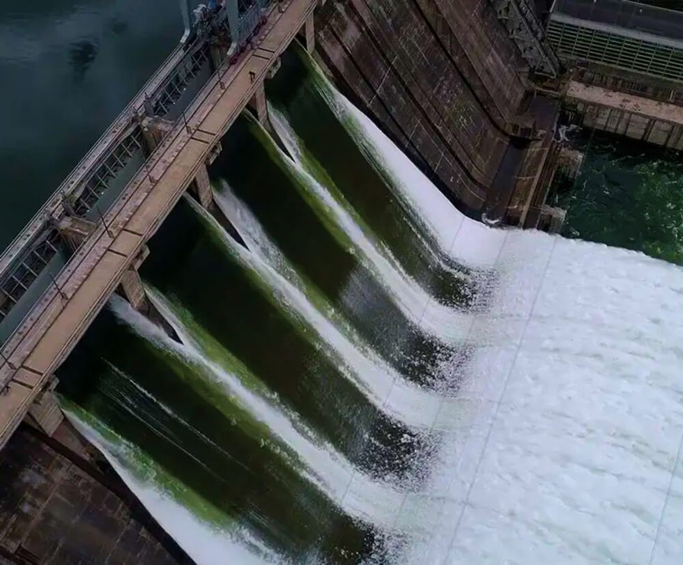 Water flowing down a dam viewed from above.